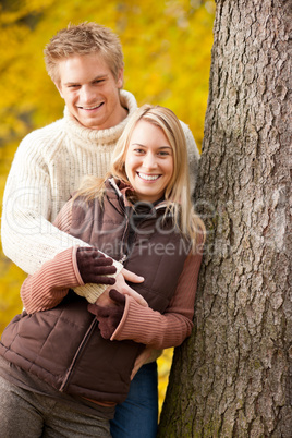 Autumn love couple hugging happy in park