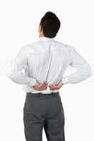 Portrait of the painful back of a young businessman