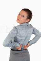 Portrait of a young businesswoman having back pain