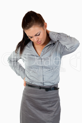 Portrait of a cute businesswoman having back pain