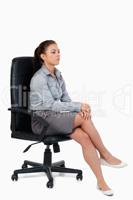 Portrait of a serious businesswoman sitting on an armchair