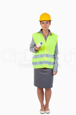 Portrait of a serious female builder with a plan