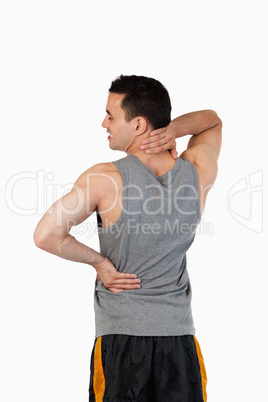 Portrait of a sports man having a back pain