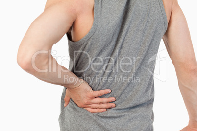 Male hands touching own spine