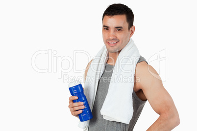 Young male with a bottle after workout