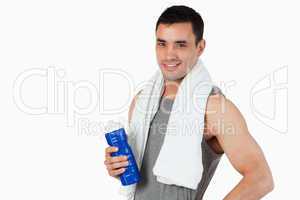 Young male with a bottle after workout