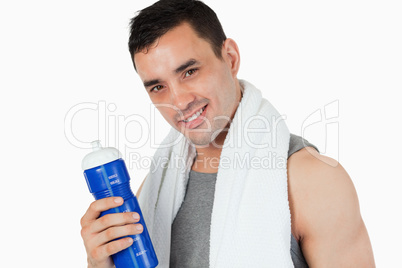 Young man with his bottle after training