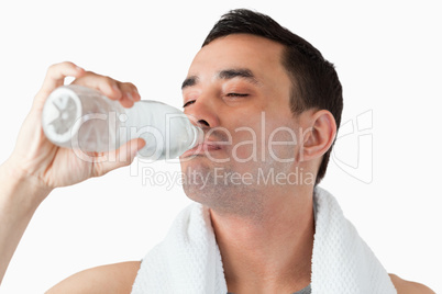 Young male enjoying a sip of water after workout