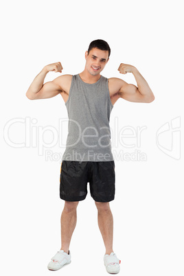 Young male presenting his muscles