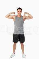 Young man presenting his muscles