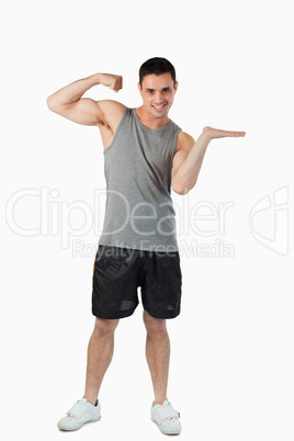 Young man showing his biceps while presenting