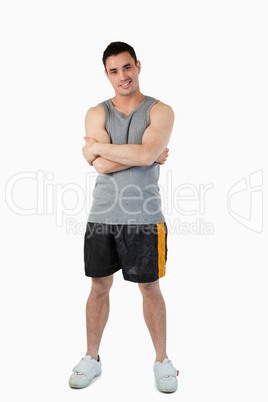 Sporty young male with arms folded