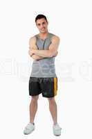 Sporty young male with arms folded