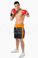 Young boxer performing a left hook