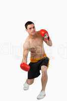 Young boxer starting to perform uppercut