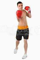 Young male boxer performing uppercut