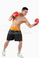 Side view of boxer performing uppercut