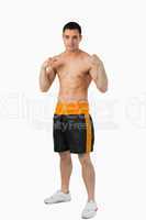 Young boxer with bare fists up