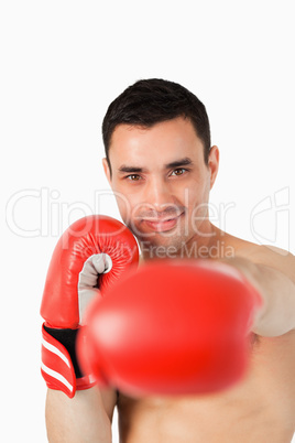 Smiling boxer attacking with his left fist
