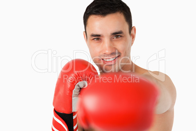 Smiling boxer striking with left fist