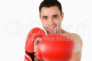 Smiling boxer striking with left fist