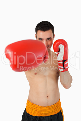 Smiling boxer attacking with his right fist