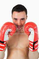 Confident looking boxer behind cover
