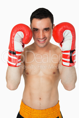 Smiling young boxer taking cover