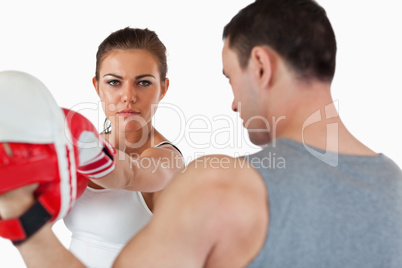 Confident looking female with her martial arts trainer