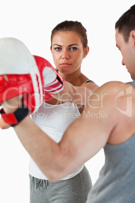 Young woman with her martial arts trainer