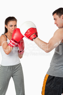 Young female training boxing