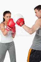 Young female training boxing