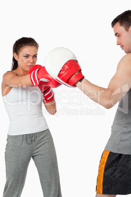 Young female boxer focused on her target
