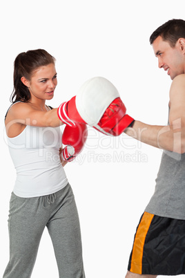 Female boxer listening to her instructor