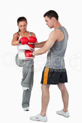 Young female martial arts fighter practicing her knee technique