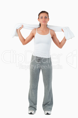 Young female putting towel around her neck