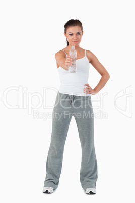 Young woman with hand on her hip offering a sip of water