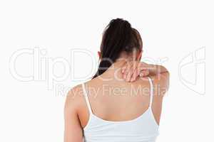 Back view of woman with pain in her neck