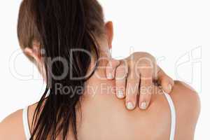 Back view of young woman with neck pain
