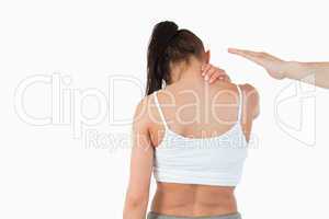 Back view of female having neck pain