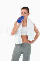 Sportswoman taking a sip out of her bottle