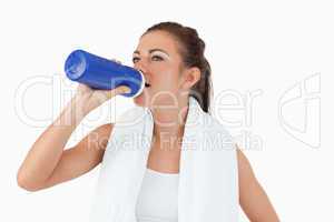 Atletic female taking a sip of water after workout