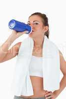 Young female drinking water after workout