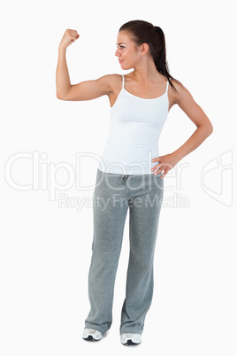 Young woman showing her biceps