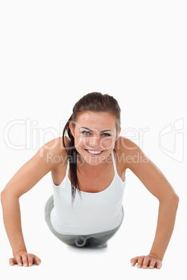 Smiling woman doing push ups