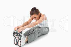 Young female doing stretches before workout