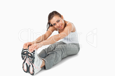 Young woman stretching before training