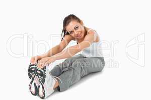 Young woman stretching before training