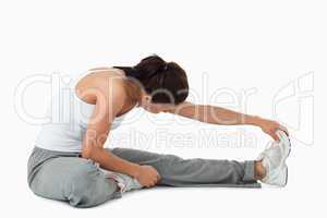 Side view of woman doing stretches