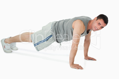 Side view of man doing push ups